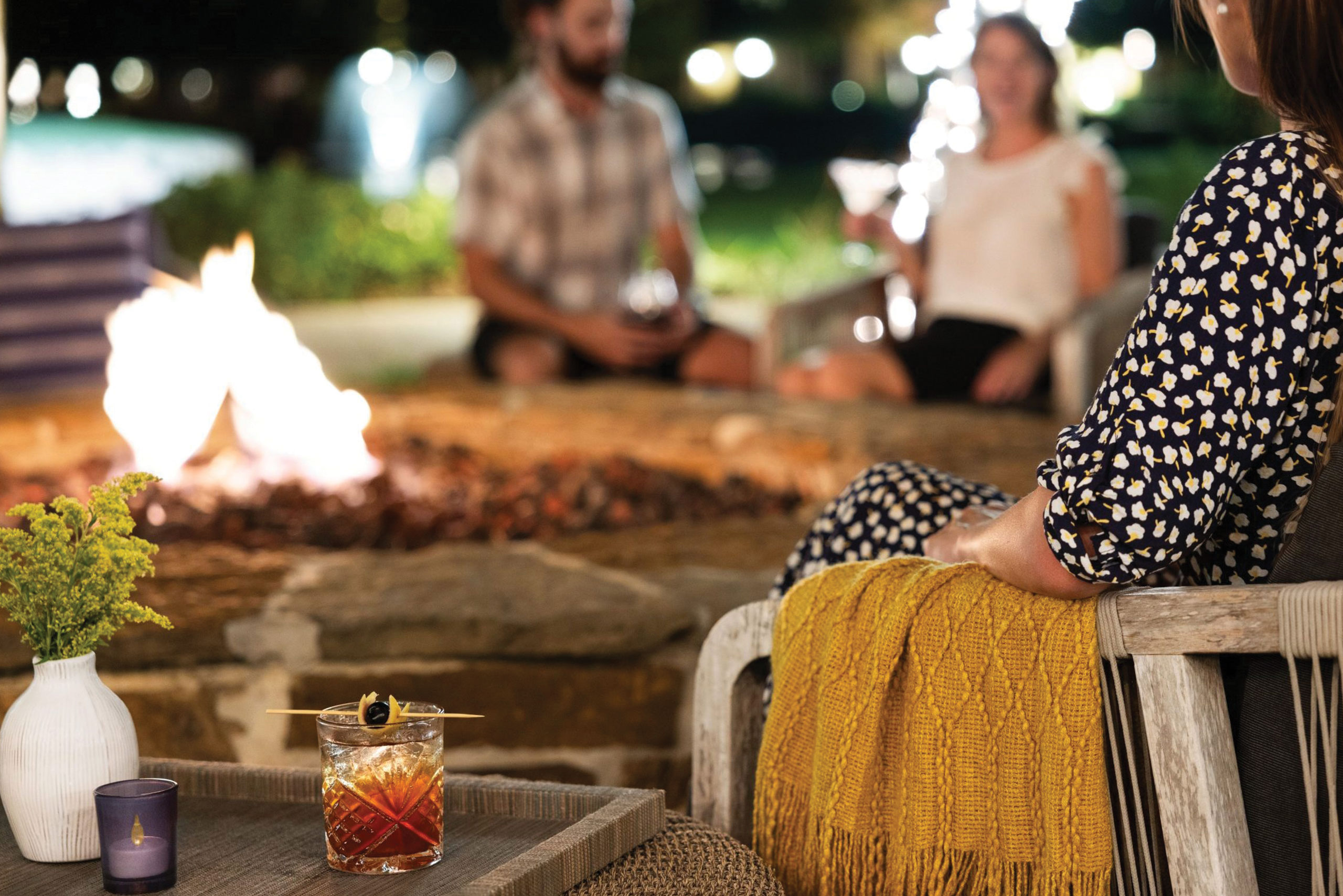 pic of guests enjoying firepits at The Woodlands Resort