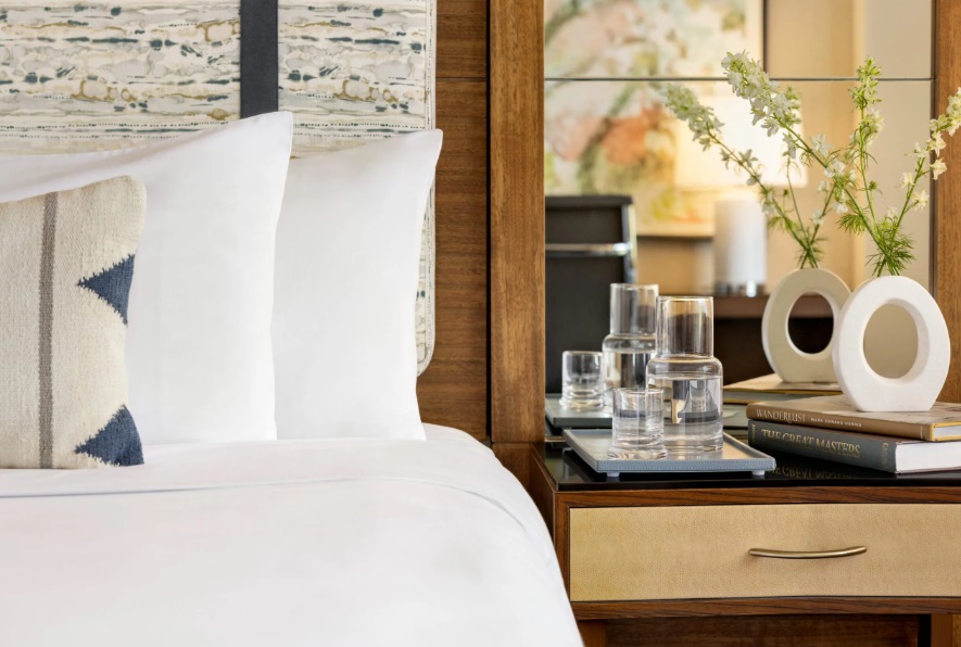 image of guest room bed and nightstand at The Woodland Resort